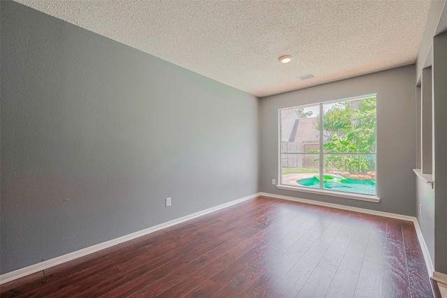 9911 Villa Verde Dr, Houston, TX 77064 - unfurnished room featuring dark wood finished floors, a textured ceiling, and baseboards