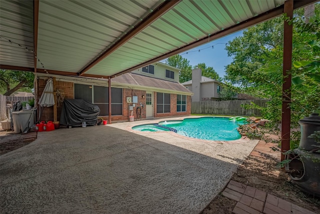 9911 Villa Verde Dr, Houston, TX 77064 - view of swimming pool with a patio, a fenced backyard, a sunroom, and a pool with connected hot tub