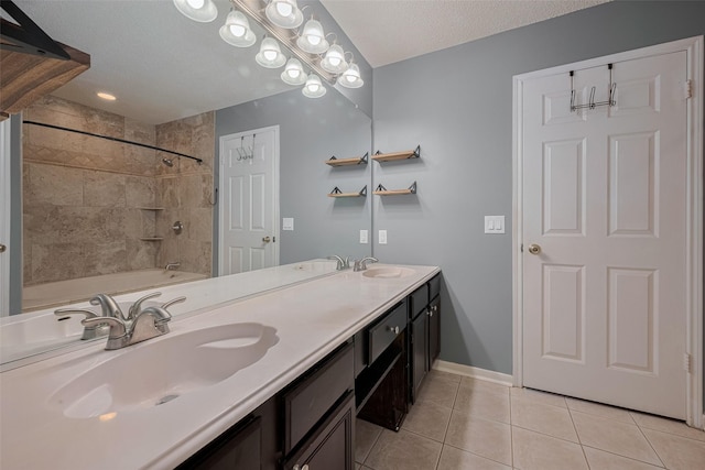 9911 Villa Verde Dr, Houston, TX 77064 - full bathroom featuring tile patterned flooring, double vanity, baseboards, a textured ceiling, and shower / washtub combination