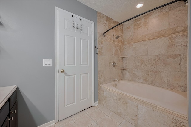 9911 Villa Verde Dr, Houston, TX 77064 - full bathroom featuring tile patterned flooring, tiled shower / bath, a textured ceiling, vanity, and baseboards