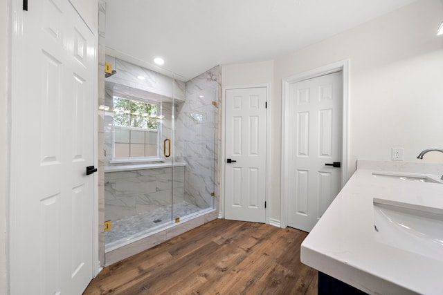 52 S High Oaks Cir, The Woodlands, TX 77380 - bathroom featuring wood finished floors, a marble finish shower, recessed lighting, and double vanity
