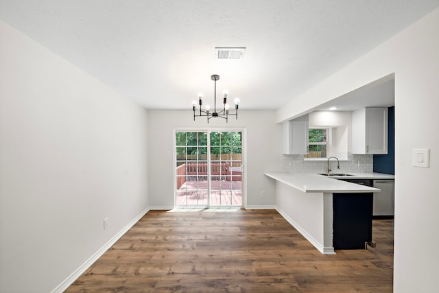 52 S High Oaks Cir, The Woodlands, TX 77380 - kitchen with a sink, stainless steel dishwasher, a chandelier, light countertops, and wood finished floors