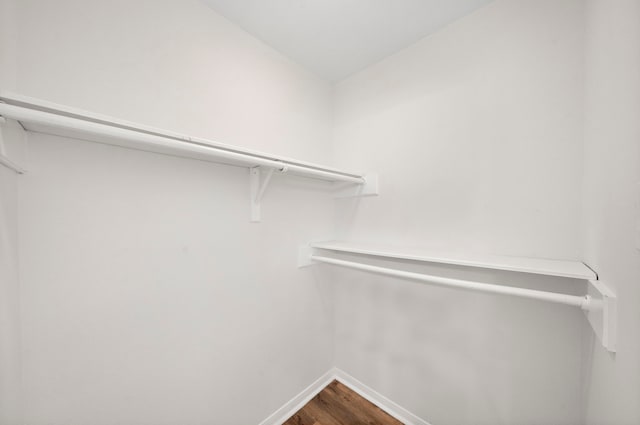 52 S High Oaks Cir, The Woodlands, TX 77380 - walk in closet featuring dark wood-type flooring