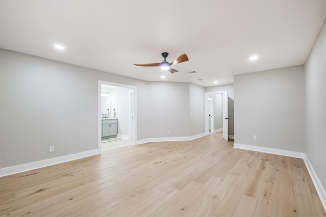 empty room with a ceiling fan, recessed lighting, light wood finished floors, and baseboards