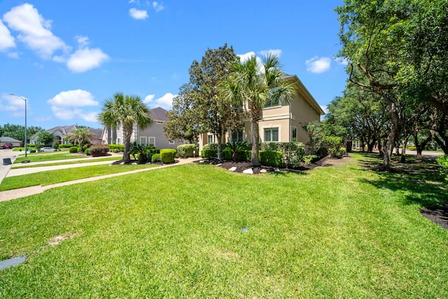 20002 Meadow Arbor Ct, Katy, TX 77450 - view of property hidden behind natural elements with stucco siding, a front yard, and a residential view