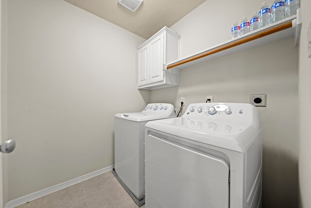 20002 Meadow Arbor Ct, Katy, TX 77450 - laundry area featuring cabinet space, washing machine and clothes dryer, baseboards, and light tile patterned flooring