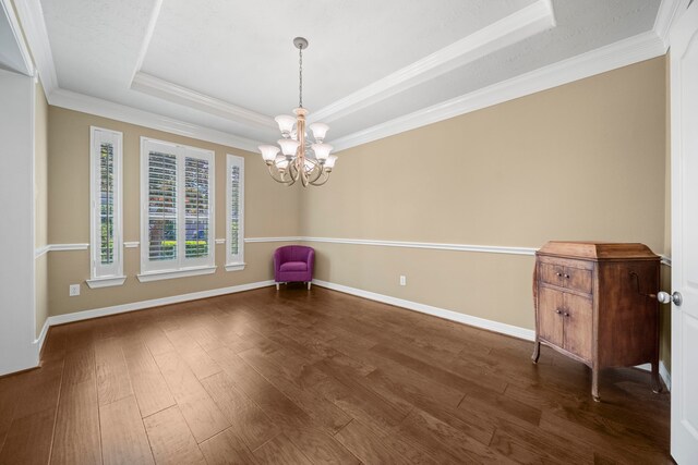 20002 Meadow Arbor Ct, Katy, TX 77450 - spare room with a tray ceiling, a chandelier, baseboards, dark wood-style flooring, and ornamental molding