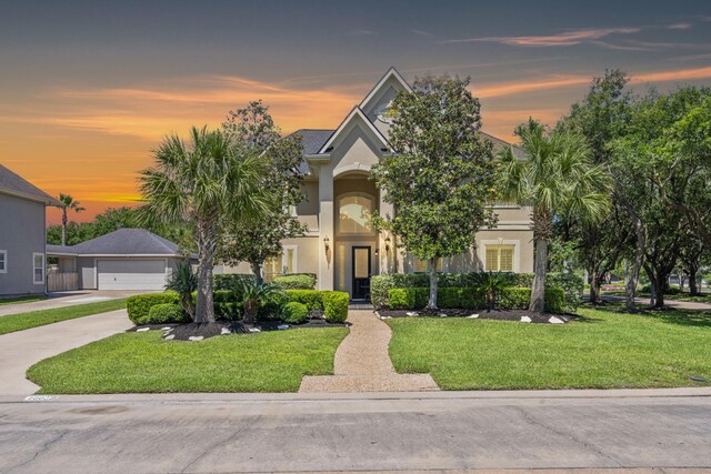 20002 Meadow Arbor Ct, Katy, TX 77450 - view of front of home featuring stucco siding, a front yard, a detached garage, and driveway