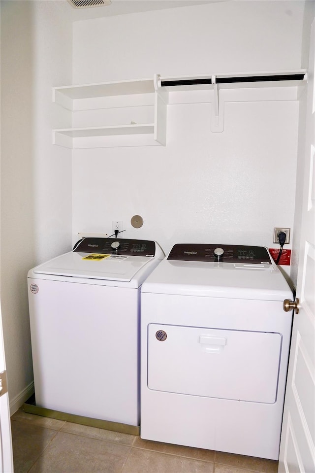 9829 Heritage Run Ln, Houston, TX 77080 - clothes washing area featuring washing machine and dryer, light tile patterned floors, and baseboards
