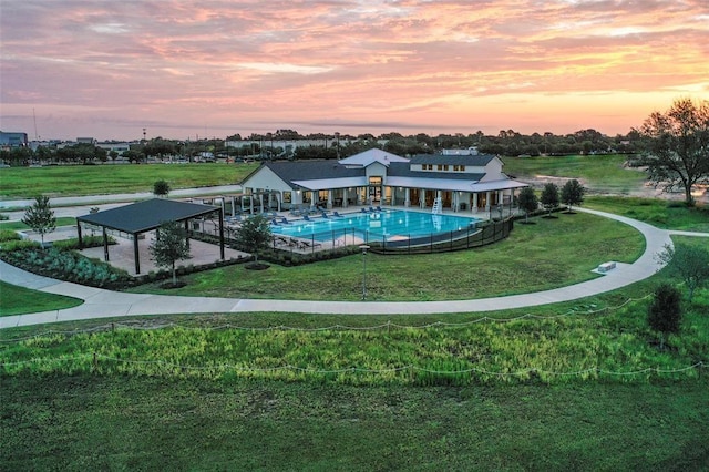 9829 Heritage Run Ln, Houston, TX 77080 - pool at dusk with a gazebo, an outdoor pool, a lawn, and a patio