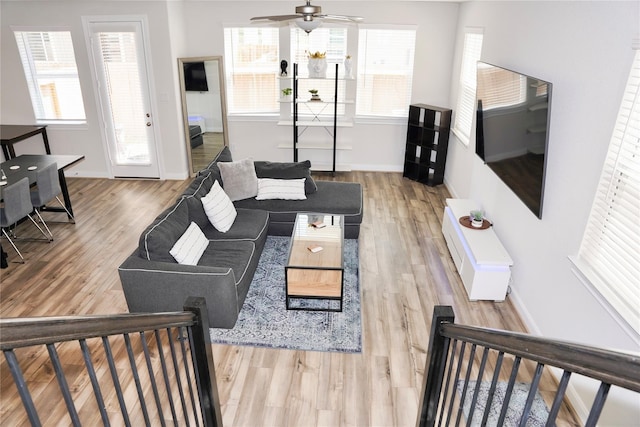9829 Heritage Run Ln, Houston, TX 77080 - living room with a ceiling fan, healthy amount of natural light, wood finished floors, and baseboards