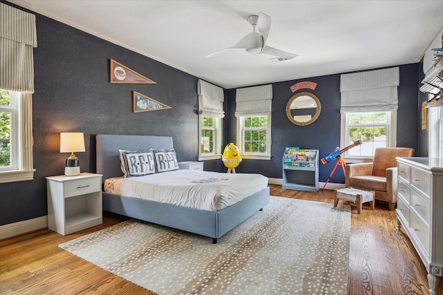 2618 Sunset Blvd, West University Place, TX 77005 - bedroom with an accent wall, wood finished floors, ceiling fan, and baseboards