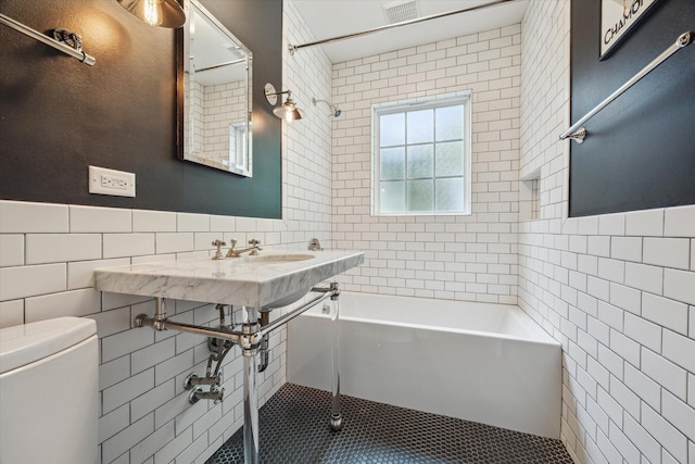 2618 Sunset Blvd, West University Place, TX 77005 - full bathroom featuring tile walls, toilet, and tile patterned flooring