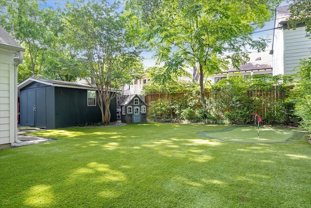 2618 Sunset Blvd, West University Place, TX 77005 - view of yard featuring a storage shed, an area to practice putting, and an outbuilding