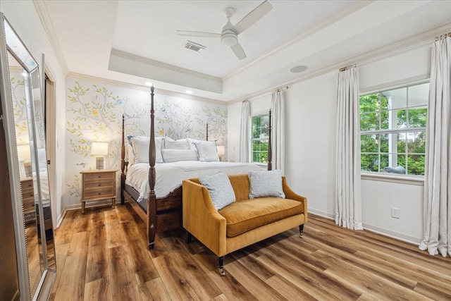2618 Sunset Blvd, West University Place, TX 77005 - bedroom featuring ornamental molding, a raised ceiling, multiple windows, wood finished floors, and baseboards