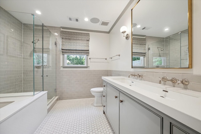 2618 Sunset Blvd, West University Place, TX 77005 - bathroom with tile walls, toilet, a stall shower, vanity, and recessed lighting