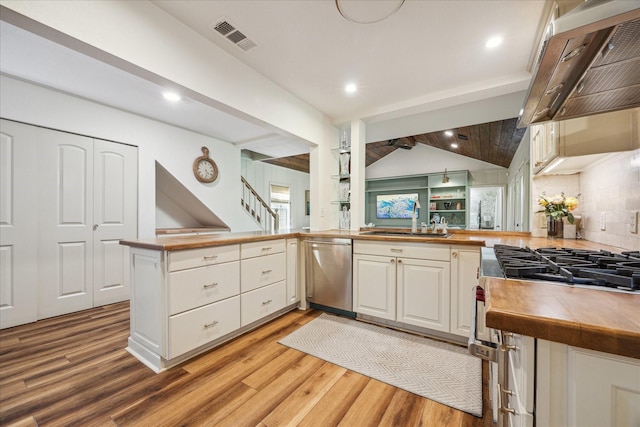 2618 Sunset Blvd, West University Place, TX 77005 - kitchen featuring stainless steel dishwasher, a sink, a peninsula, light wood-style flooring, and white cabinetry