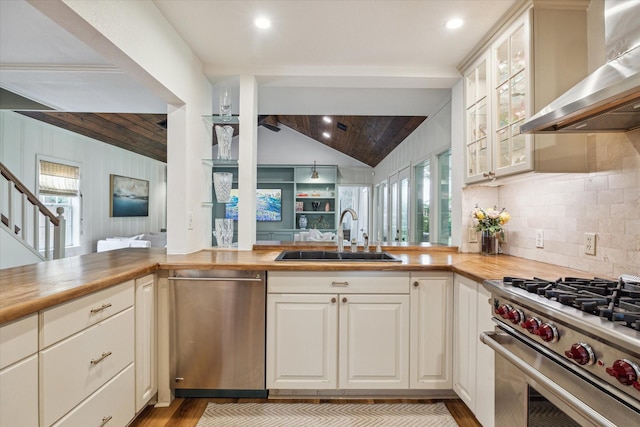 2618 Sunset Blvd, West University Place, TX 77005 - kitchen with wall chimney exhaust hood, stainless steel appliances, a sink, light wood-type flooring, and recessed lighting