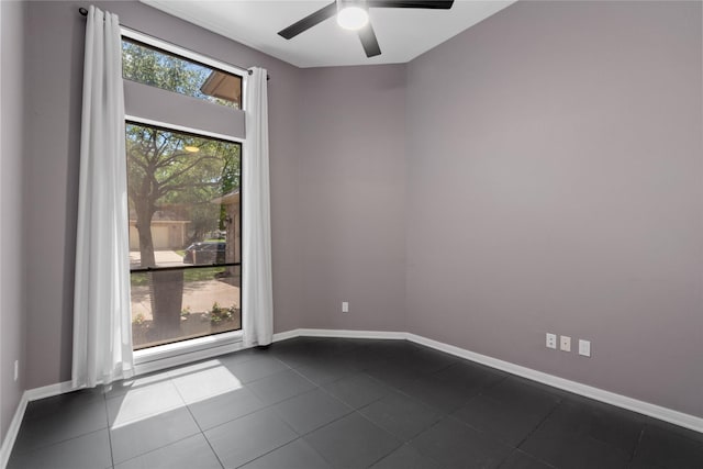 14834 Plantation Oak Dr, Houston, TX 77068 - empty room with a ceiling fan, baseboards, and dark tile patterned floors