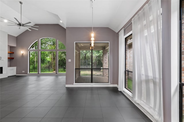 14834 Plantation Oak Dr, Houston, TX 77068 - unfurnished living room featuring vaulted ceiling, a ceiling fan, plenty of natural light, dark tile patterned flooring, and baseboards