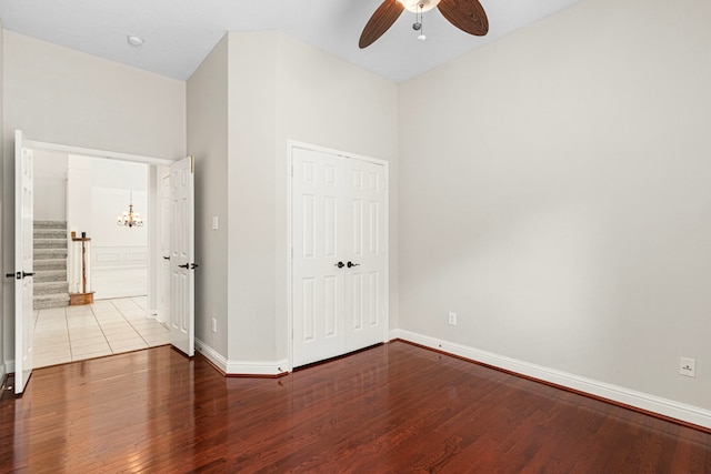 1807 Rustic Hills Ct, Sugar Land, TX 77479 - unfurnished bedroom with wood finished floors, baseboards, a closet, and a chandelier