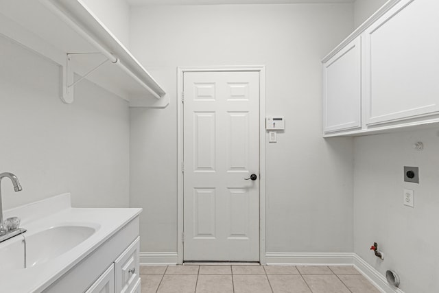1807 Rustic Hills Ct, Sugar Land, TX 77479 - clothes washing area featuring hookup for a gas dryer, light tile patterned flooring, baseboards, and electric dryer hookup