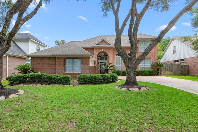 1807 Rustic Hills Ct, Sugar Land, TX 77479 - view of front facade with brick siding, driveway, and roof with shingles
