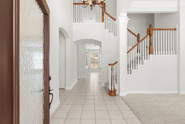 1807 Rustic Hills Ct, Sugar Land, TX 77479 - foyer entrance with arched walkways, stairs, a chandelier, a towering ceiling, and light tile patterned floors