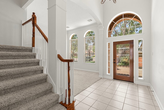 1807 Rustic Hills Ct, Sugar Land, TX 77479 - foyer with stairs, decorative columns, light tile patterned floors, and baseboards
