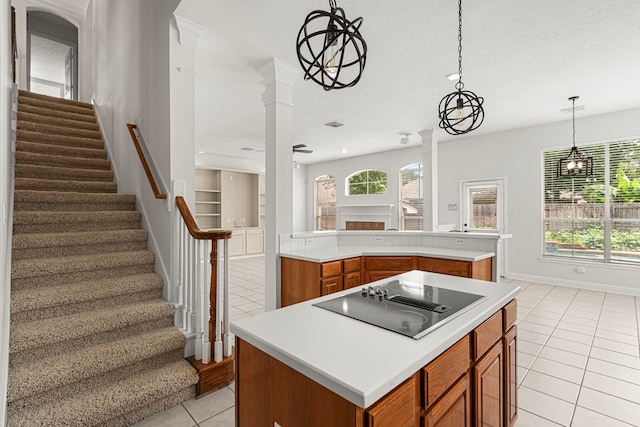 1807 Rustic Hills Ct, Sugar Land, TX 77479 - kitchen with black electric cooktop, light tile patterned flooring, brown cabinetry, a center island, and light countertops