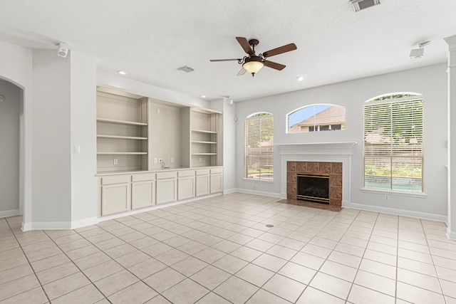 1807 Rustic Hills Ct, Sugar Land, TX 77479 - unfurnished living room with baseboards, a ceiling fan, a tiled fireplace, recessed lighting, and light tile patterned floors