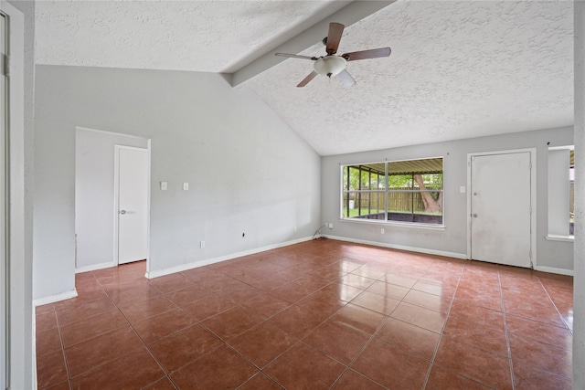 empty room featuring a textured ceiling, dark tile patterned floors, ceiling fan, and baseboards