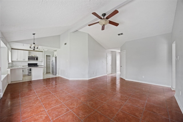unfurnished living room featuring a ceiling fan, a textured ceiling, dark tile patterned flooring, a sink, and high vaulted ceiling
