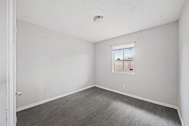 unfurnished room with baseboards