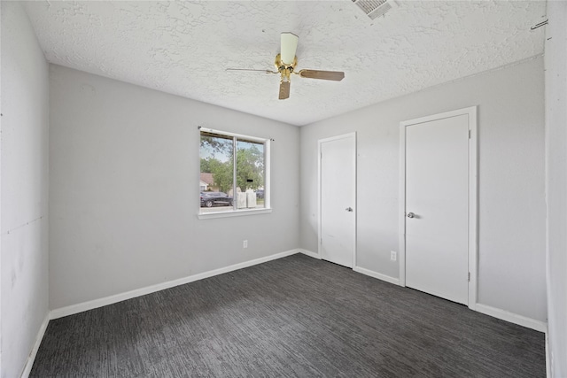unfurnished bedroom featuring a textured ceiling, a ceiling fan, and baseboards