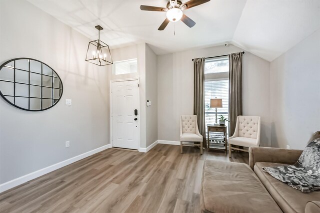 20810 Oak Rain Ct, Katy, TX 77449 - living area featuring light wood-type flooring, a chandelier, baseboards, a ceiling fan, and vaulted ceiling