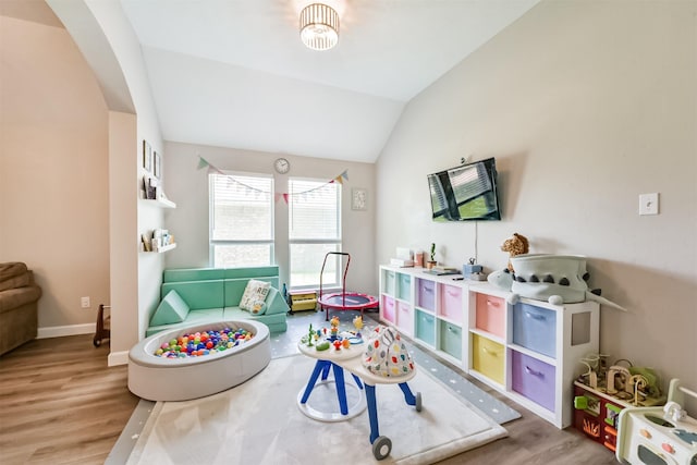 20810 Oak Rain Ct, Katy, TX 77449 - playroom with wood finished floors, arched walkways, vaulted ceiling, and baseboards