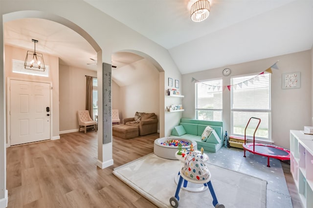 20810 Oak Rain Ct, Katy, TX 77449 - entrance foyer featuring arched walkways, wood finished floors, vaulted ceiling, and baseboards