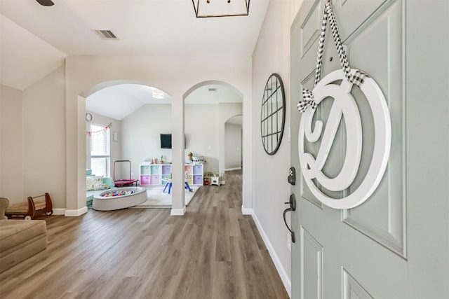20810 Oak Rain Ct, Katy, TX 77449 - foyer entrance featuring arched walkways, light wood-type flooring, lofted ceiling, and baseboards