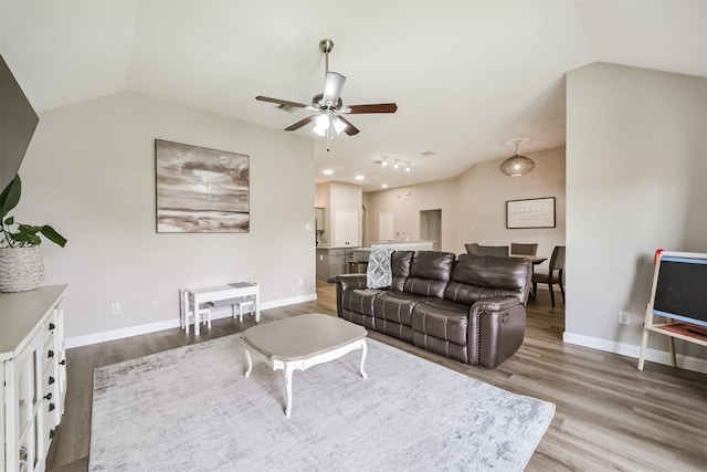 20810 Oak Rain Ct, Katy, TX 77449 - living room featuring a ceiling fan, vaulted ceiling, wood finished floors, and baseboards
