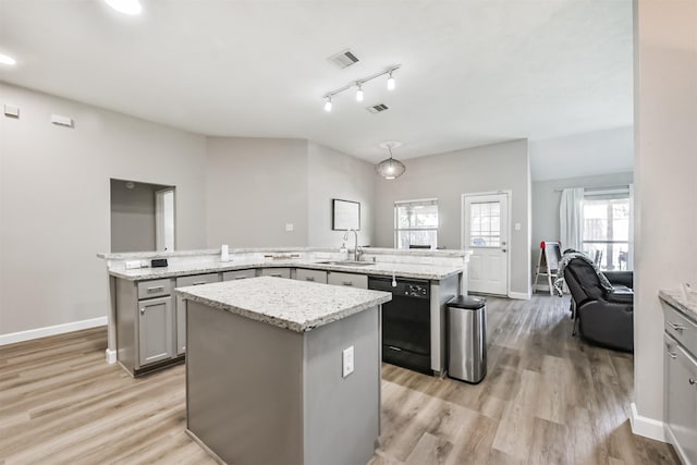 20810 Oak Rain Ct, Katy, TX 77449 - kitchen featuring dishwasher, a sink, a center island, gray cabinets, and baseboards