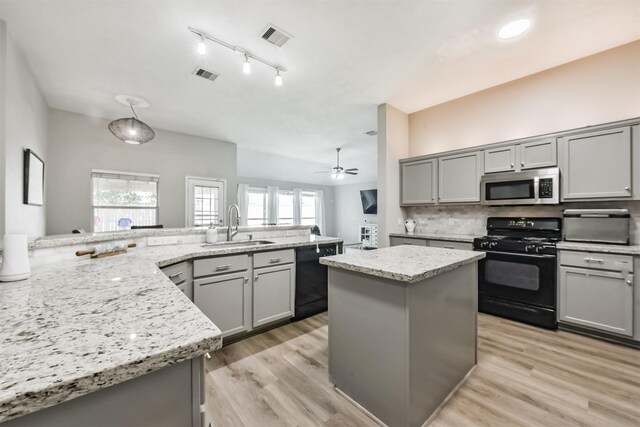 20810 Oak Rain Ct, Katy, TX 77449 - kitchen with black appliances, gray cabinets, a sink, tasteful backsplash, and light stone countertops