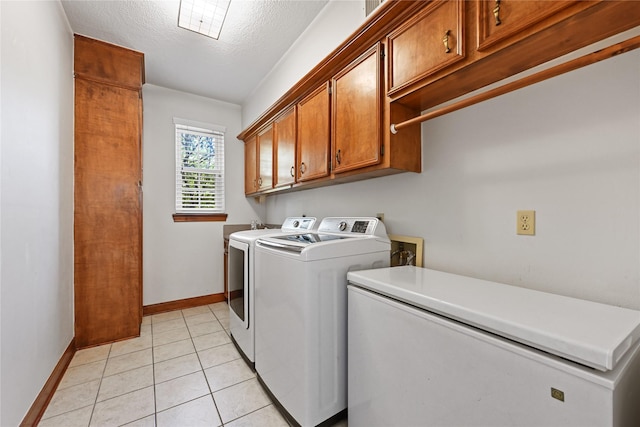17414 Naremore Ct, Spring, TX 77379 - washroom with cabinet space, separate washer and dryer, baseboards, light tile patterned floors, and a textured ceiling