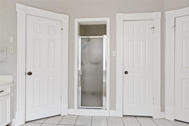 17414 Naremore Ct, Spring, TX 77379 - bathroom featuring a shower stall, tile patterned floors, and baseboards