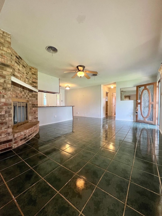 703 W Park St, Vidor, TX 77662 - unfurnished living room with tile patterned flooring, a ceiling fan, a fireplace, and baseboards
