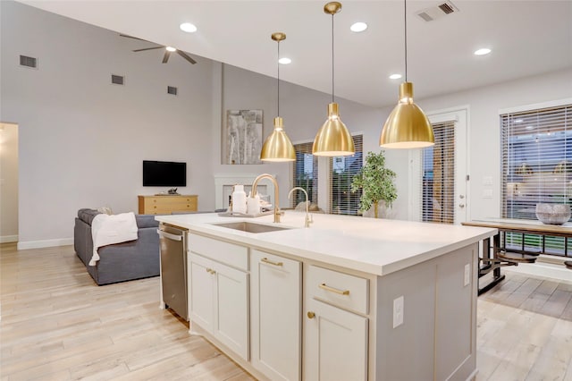 2327 Partridgeberry Ln, Katy, TX 77494 - kitchen featuring a sink, open floor plan, light wood-style floors, dishwasher, and light countertops