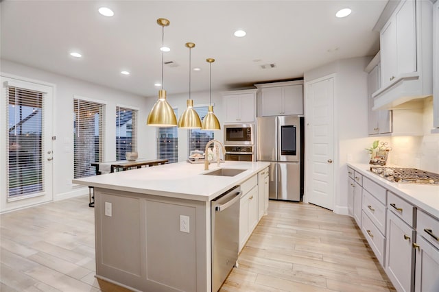 2327 Partridgeberry Ln, Katy, TX 77494 - kitchen with stainless steel appliances, a sink, recessed lighting, light wood-type flooring, and tasteful backsplash
