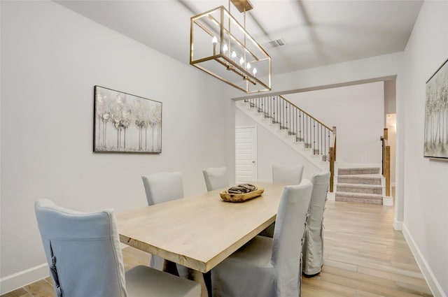 2327 Partridgeberry Ln, Katy, TX 77494 - dining area featuring stairway, a chandelier, baseboards, and wood finished floors