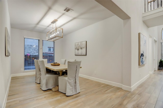 2327 Partridgeberry Ln, Katy, TX 77494 - dining room with light wood-type flooring, a chandelier, and baseboards