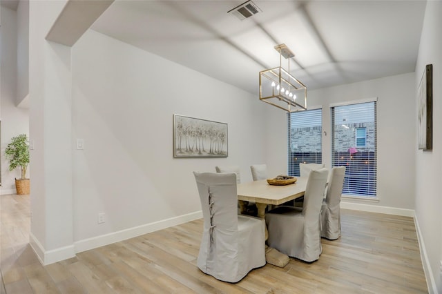 2327 Partridgeberry Ln, Katy, TX 77494 - dining area featuring light wood finished floors, baseboards, and a chandelier